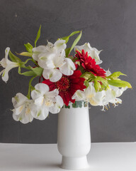 White vase with red and white flowers