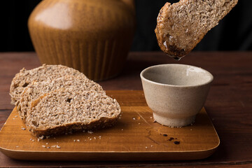 Dipping the wheat bread.