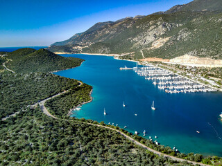 Fototapeta premium The top view from the drone of Kas resorts and city with amazing blue and clear lagoon and yachts in Mugla province of Turkey