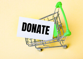 The card with the word DONATE is in the shopping cart. Marketing concept