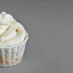 Milky cream cupcake. Birthday sweet bakery. Cookies. Yummy buttercream dessert. Wedding party food. Grey background. Holiday recipe. Anniversary gourmet. Closeup. One piece