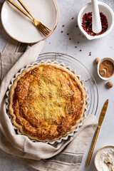 Just baked open French quiche Lorraine pie with crispy crust cools after baking on the table, ready to eat. Top view.