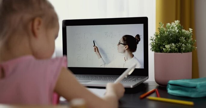 distance education - primary school math teacher explaining basic mathematics online. little girl using laptop for learning at home