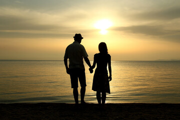 silhouette of a  loving couple at sunset on the seashore