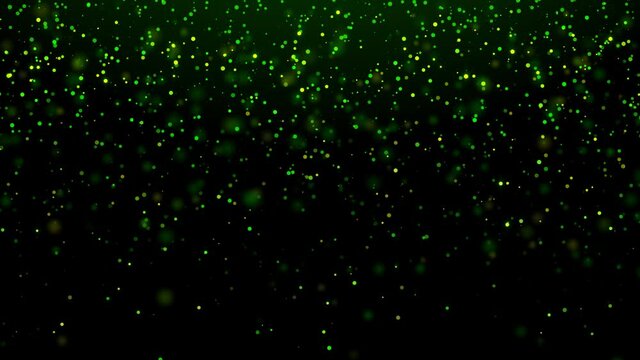 A looped motion background of falling emerald-green and gold sparkling particles. For St. Patrick's day. For Wallpapers, greetings, screensavers. Bright green and gold color, bokeh effect.