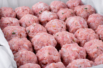 Raw meatballs with rice in the oven tray prepared to be roasted. Making a hot meal