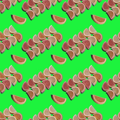 Seamless candy pattern of marmalade in the form of citrus slices laid out in rows on a green background. Jelly sweet candies. Beautiful wide-angle wallpaper or web banner. Top view.