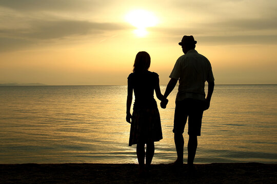 silhouette of a  loving couple at sunset on the seashore