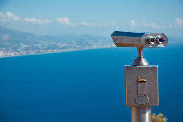 Tourist binoculars on famous sea panorama landscape of Alanya Castle in Antalya district, Turkey. Popular tourist destination with high mountains. Summer sunny day and beautiful sea with copy space