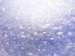 Winter abstract background. Snow illuminated by the rays of the sun