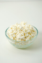 A glass bowl with cotton cheese