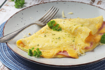 Omelette with ham and cheese on the plate