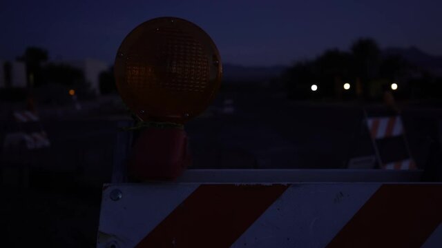 Flashing lights of a traffic barricade at dusk