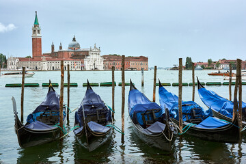Fototapeta na wymiar A view of San Giorgio Maggiore church seen from the main island in Venice, Italy, with gondolas in the foreground.