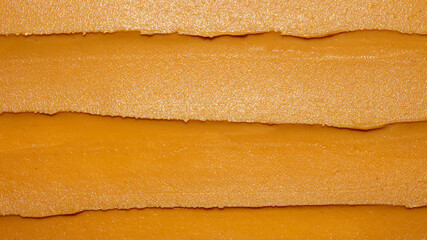 Light brown peanut paste made from whole nuts.Peanut paste background top view.Peanut paste texture...