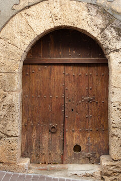 Old wooden door with stone arch