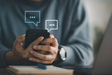 Women hand using smartphone typing Live chat chatting and social network concepts, chatting conversation working at home in chat box icons pop up. Social media marketing technology concept.