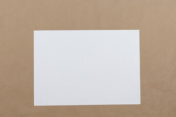White sheet of paper on a craft background.