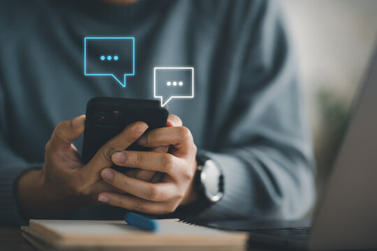 Women hand using smartphone typing Live chat chatting and social network concepts, chatting conversation working at home in chat box icons pop up. Social media marketing technology concept.