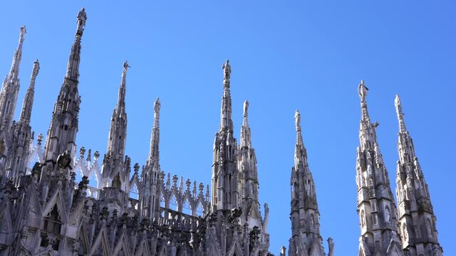 Milan , Italy march 2021  - spiers of the cathedral ( Duomo ) in a sunny day with blue sky during covid-19 Coronavirus lockdown quarantine home 