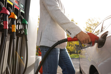 Man refueling car at self service gas station, closeup
