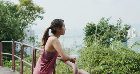 Sport woman look at the city view from mountain