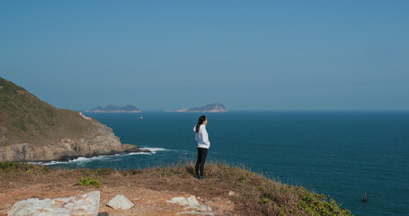 Woman stand at the top of mountain