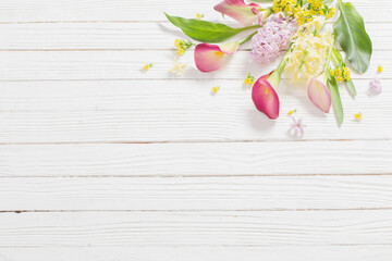 beautiful flowers on white wooden background