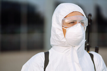Portrait of Man  in protective hazmat suit and mask. Covid-2019. Prevention of spreading  global...