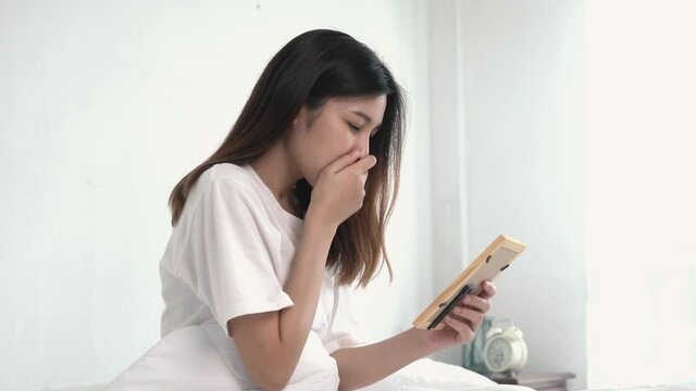 Sad woman looking at picture in  the room