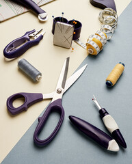 Sewing threads set of sewing accessories in the form of a canvas on a yellow-gray background