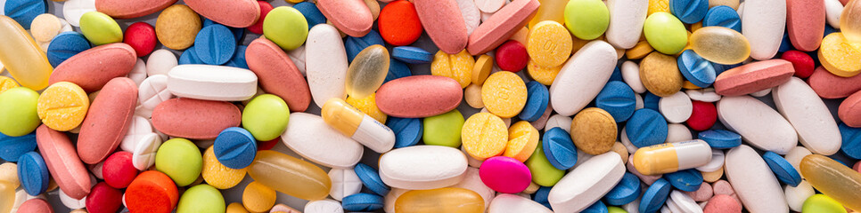 Close up of variety of colorful pills, capsules, and tablets
