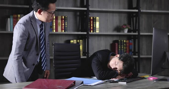 The boss catches that the lazy employee is secretly sleeping at work.