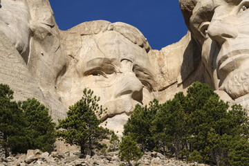 Mount Rushmore National Memorial, four ex Presidents faces sculptured into granite with blue sky...