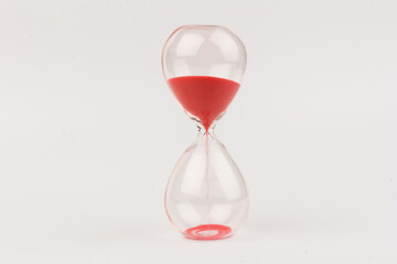 Fototapeta na wymiar Crystal hourglass on light background as a concept of passing time for business term, urgency and outcome of time.