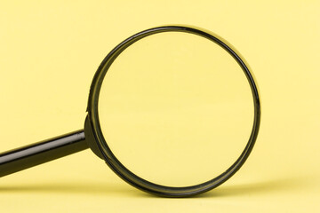 magnifying glass  loupe search symbol on yellow background with copy space