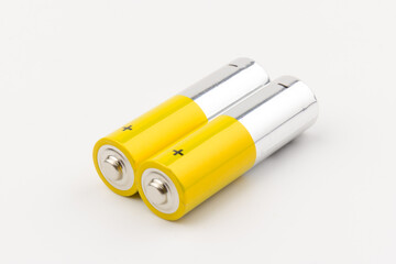 Photo of gray-yellow alkaline AA batteries on white background. Recycling of rechargeable NiMH batteries. The most popular size of accumulators. Copy space.