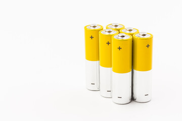 Photo of gray-yellow alkaline AA batteries on white background. Recycling of rechargeable NiMH batteries. The most popular size of accumulators. Copy space.