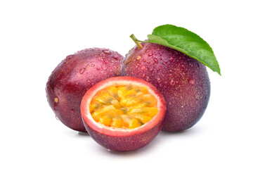 Purple passion fruit (Passiflora edulis) with cut in half and green leaf isolated on white...