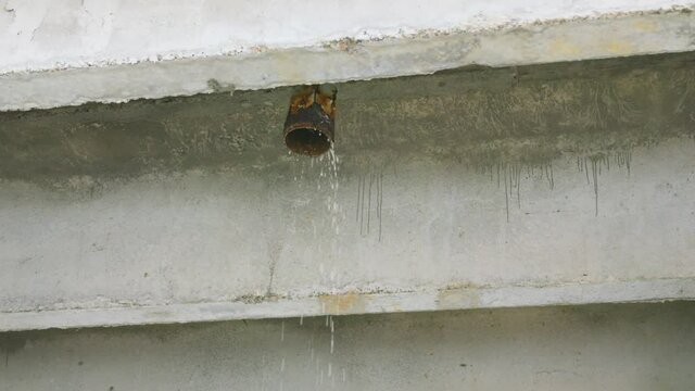 Water pipe under bridge in rainy day