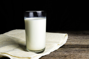 Milk on sack with a wooden table on dark background. Healthy food. Food and drink concept. Diet, Health.