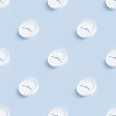 Seamless pattern with minimalistic round white wall clock on a light blue empty background. Time concept. Trendy picture.