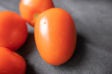 Close-up of fresh tomatoes on a dark blue table