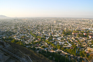 Obraz premium View over Osh town in sunset time, Kyrgyzstan. Panorama of Osh town from Sulaiman-Too mountain