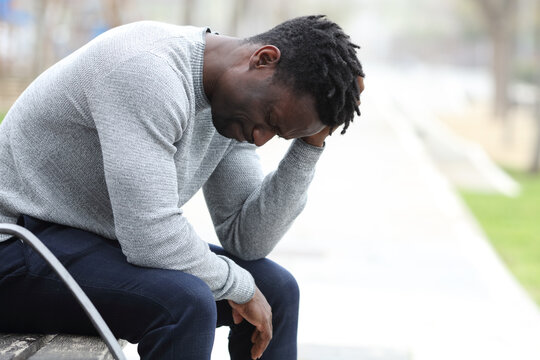 Sad Black Man Is Complaining Alone In A Park