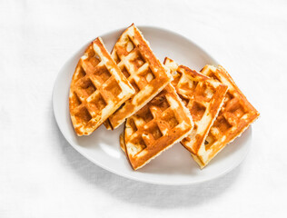 Cottage cheese waffles - delicious sweet dessert on a light background, top view