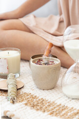 meditation space with candles and woman in background