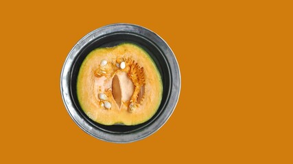 Half a pumpkin cut in a copper plate.