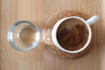 Three cups of Turkish coffee on a wooden bamboo tray.
Mortar brown in white cups
