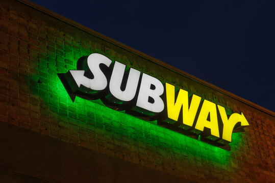 Pasadena, CA, USA - March 11, 2021: image of a lit Subway sign. Subway is an American fast food restaurant franchise that primarily sells submarine sandwiches, salads and beverages.